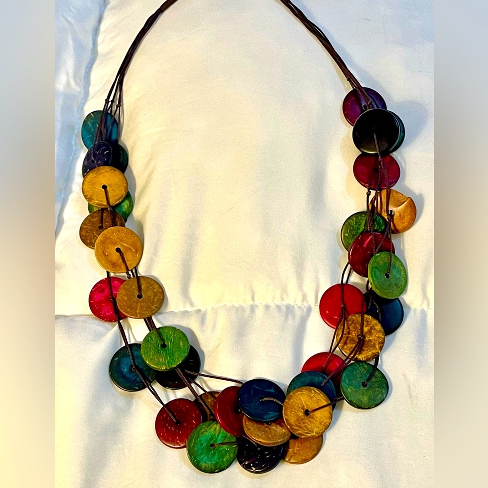 Necklace, made of colored wooden circles. Rope chain.